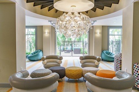 a living room with modern furniture and a large chandelier